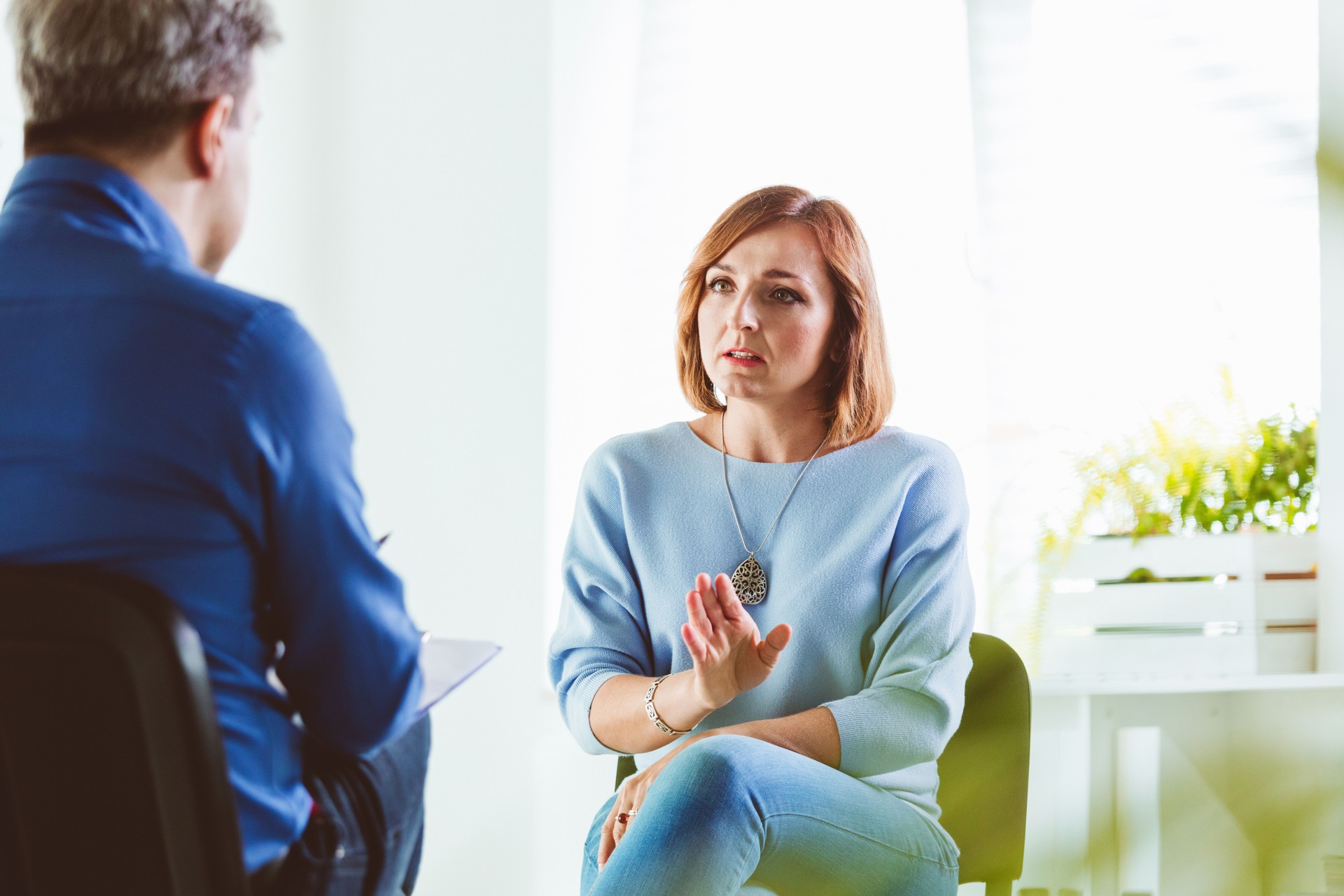 Worried woman talking with psychotherapist